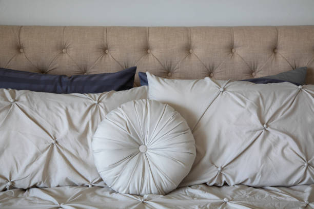 istock Pillows and cushions on a bed 2150493006