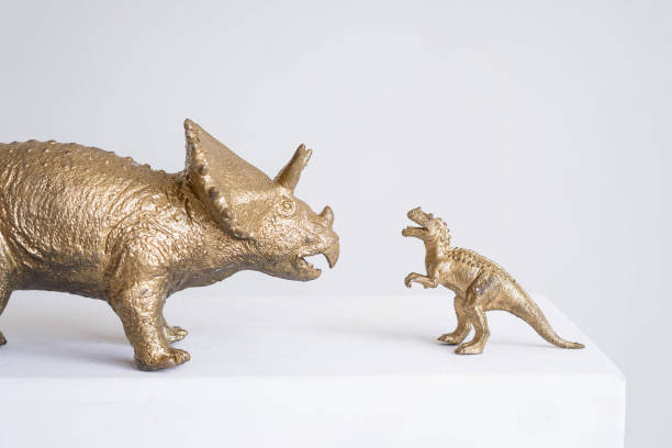 istock Golden dinosaur figurines on a white background. 2150493333