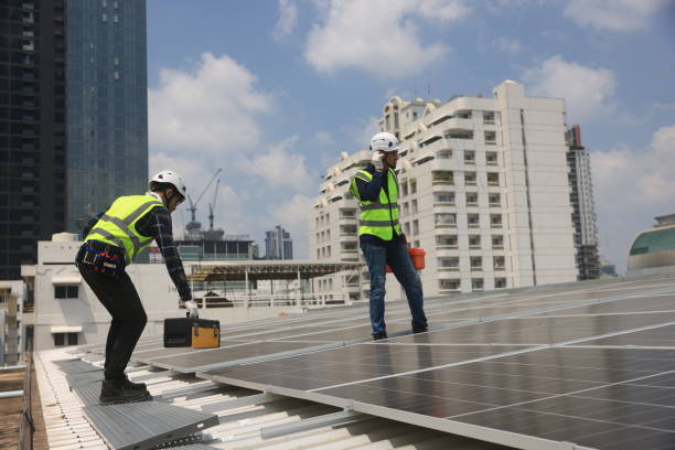 istock Two male Solar engineers working on the rooftop solar panel installations for quality assurance and maintenance. 2150495342