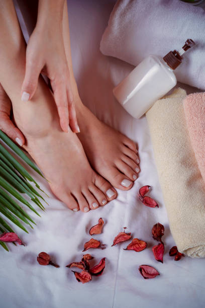 istock Hispanic young woman applying moisturizer to her feet 2150495415