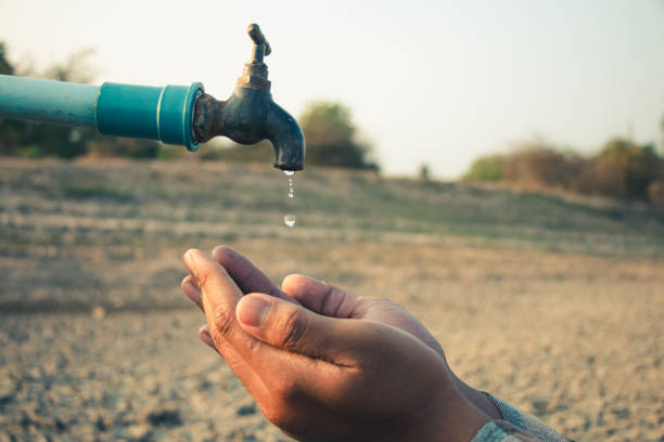 istock Hand for drinking water to live through drought, Concept drought and crisis environment. 2150495459