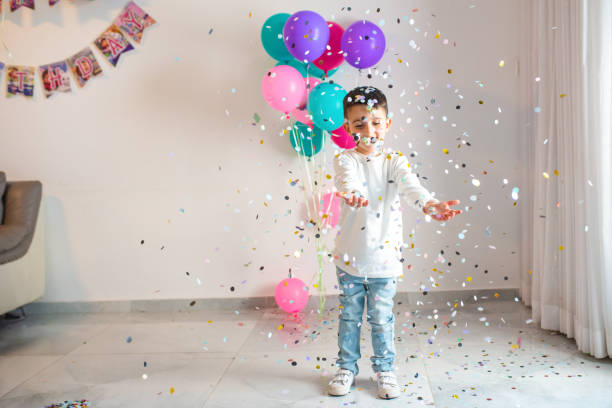 istock Child's Birthday Celebration With Balloons And Confetti. 2150496761