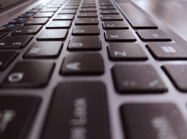 A Close up of laptop keyboard backlit keyboard.
