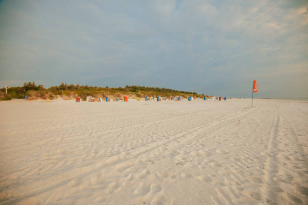 istock Beach summer background. Sea vacation.Seaside resort.White sandy beaches and Beach cabins on white sand.Beach summer mood.Vacation on the North Sea. Beaches of the Frisian Islands in Germany. 2150498832