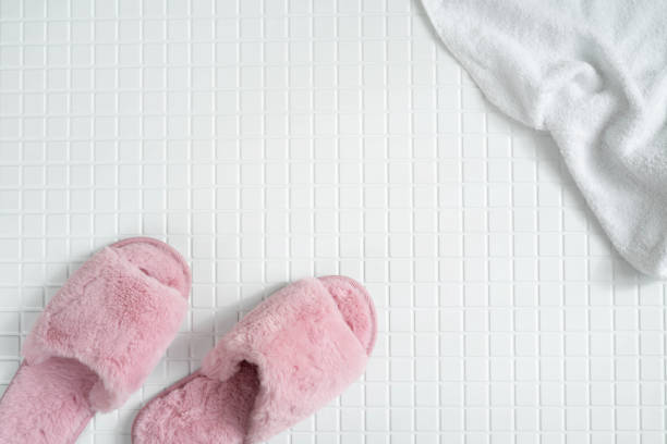 istock Fluffy pink slippers on the tiled bathroom. 2150499535