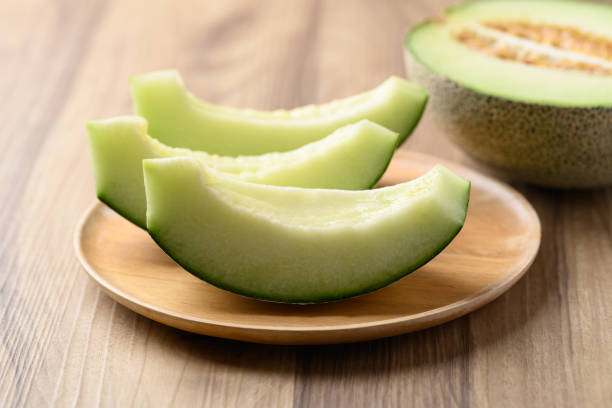 istock Green melon fruit on wooden plate ready to eating 2150506068