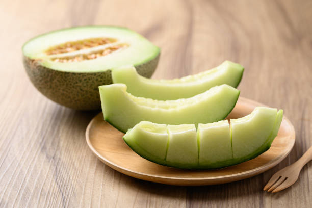 istock Green melon fruit on wooden plate ready to eating 2150506069