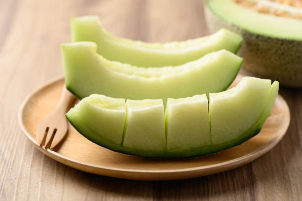 istock Green melon fruit on wooden plate ready to eating 2150506074
