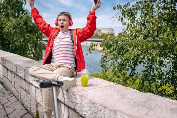 istock Teenager using mobile phone outdoors in the city 2150506544