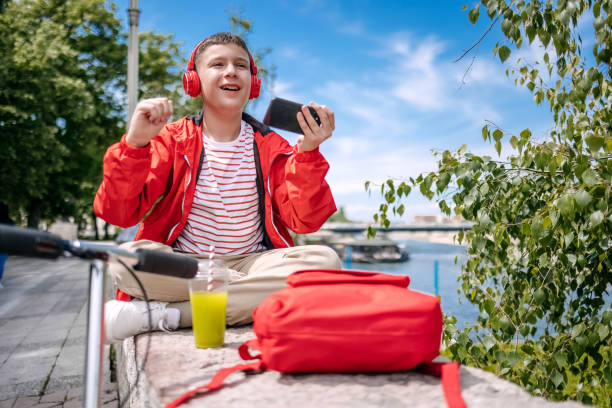 istock Teenager using mobile phone outdoors in the city 2150506545