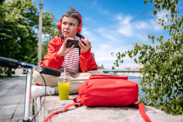 istock Teenager using mobile phone outdoors in the city 2150506559