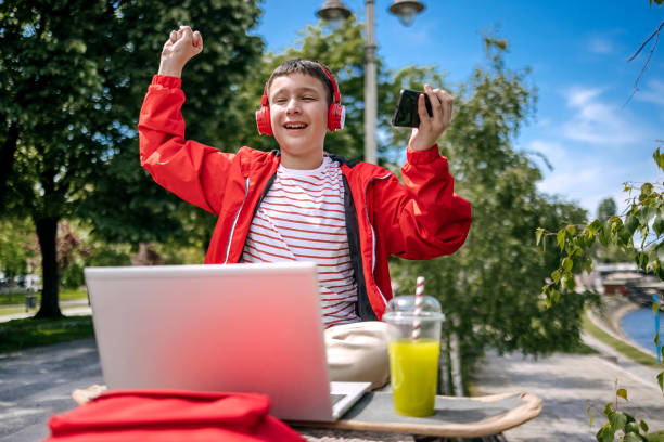 istock Teenager using mobile phone outdoors in the city 2150506572