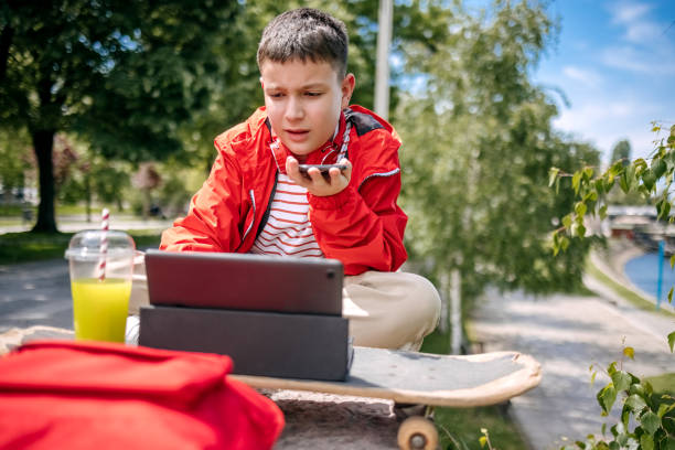 Teenager using digital tablet outdoors in the city