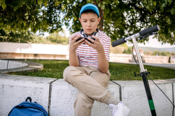 istock Teenager using mobile phone outdoors in the city 2150506648
