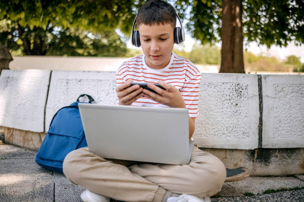 istock Teenager using mobile phone outdoors in the city 2150506673