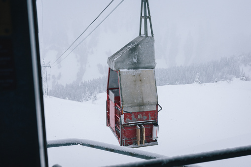 Fresh powder snow covers gondola and forest