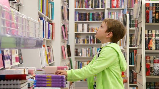 A boy choosing books in a bookstore