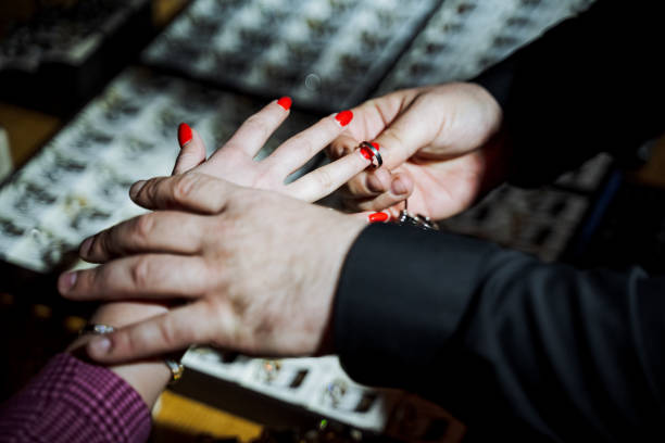 istock Man gracefully sliding wedding ring onto womans finger 2150509880