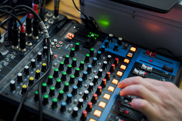 istock Hand pressing button on mixer, audio equipment in use 2150509891