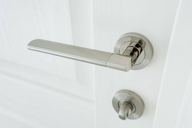 istock Chrome door handle, home hardware, lock on white door. 2150509939
