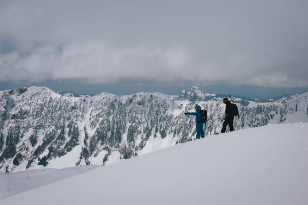 istock Backcountry skiers climb mountain 2150509940