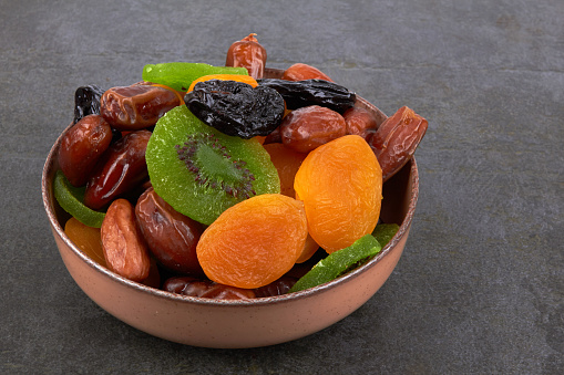 Dry fruits on a black stone background