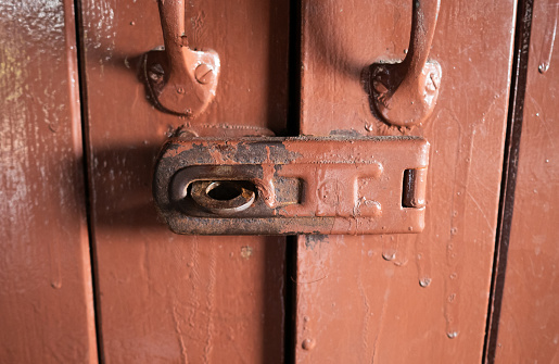 Old rusty latch on a wooden door, old rusty lock