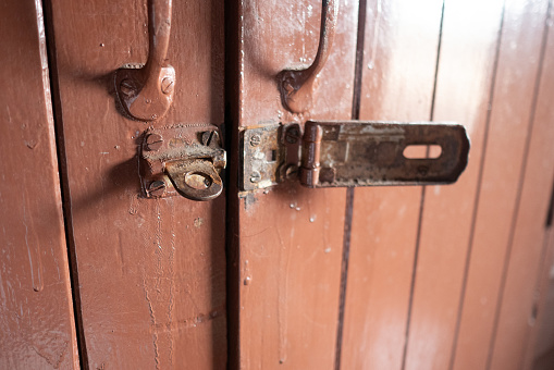 Old rusty latch on a wooden door, old rusty lock