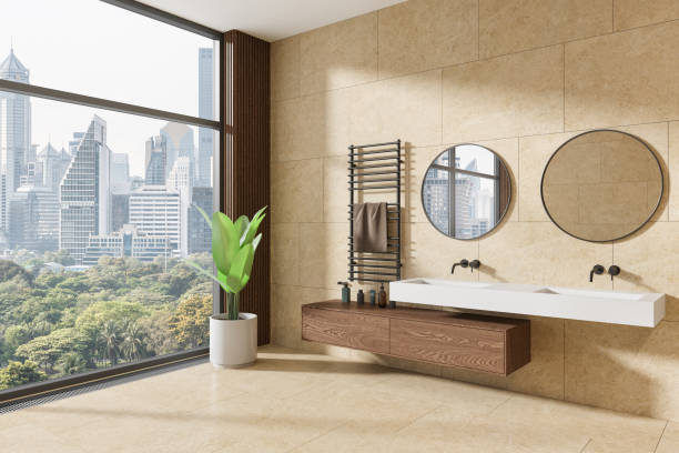 istock Beige home bathroom interior with double sink and vanity, panoramic window 2150513039