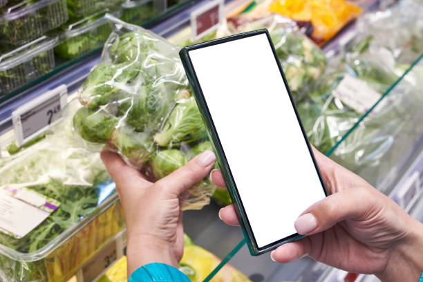 istock Brussels sprout vegetable in hand and smartphone isolated white 2150513521
