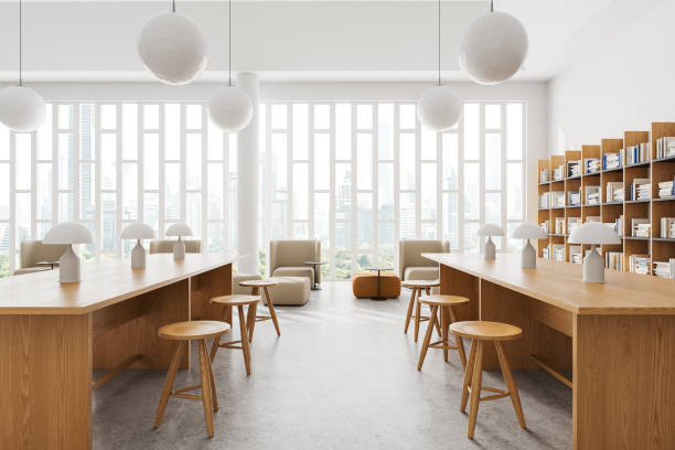 istock White library interior with bookshelf, lounge and work zone with desks 2150513571