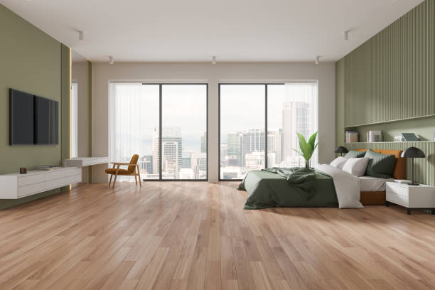 istock Green master bedroom interior with bed and TV 2150513640