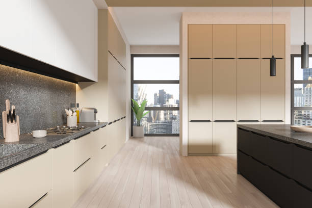 istock Beige home kitchen interior with bar counter and cooking cabinet near window 2150514121