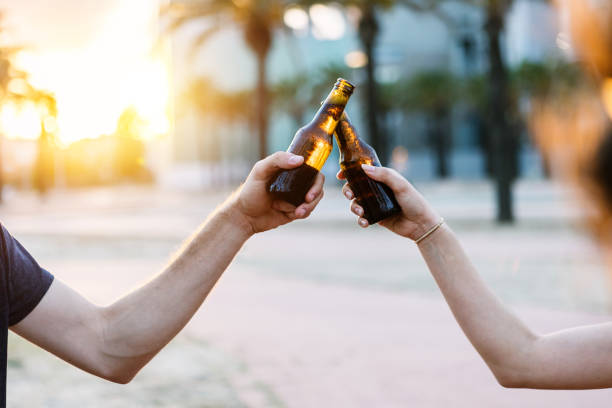 istock Two young people celebrating with beers 2150514600