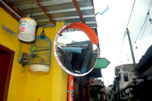A convex mirror is a curved mirror with a reflective surface that bulges outward, similar to the shape of a sphere.