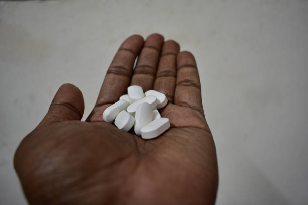istock a handful of white rectangular tablets  resting in the palm of a person's hand. 2150518494