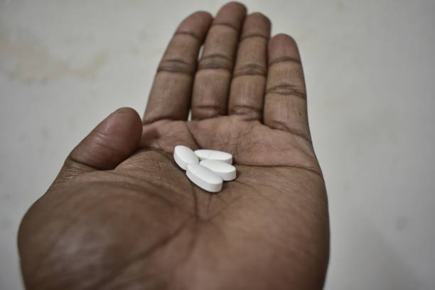istock White color pills on hand . 2150518519