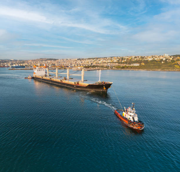 Tugboat Pulling Industrial Ship
