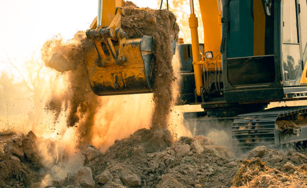 istock Close-up of excavator at construction site. Backhoe digging soil for earthwork and construction business. Excavating machine at work. Heavy machinery for earth moving and construction site development 2150520644