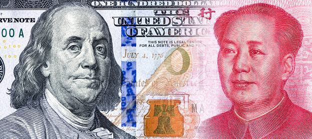 American Dollars banknote with Benjamin Franklin portrait smoothly into the Chinese Yuan with Mao Zedong. Business concept of Currency competition exchange rate, stock exchange, trading