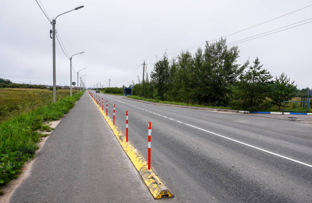 istock Dedicated fenced off bicycle path on an asphalt highway 2150520848