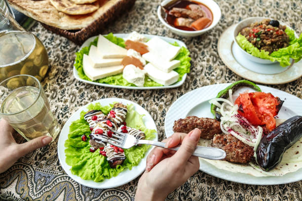 istock Table With Assorted Plates of Food and Drinks 2150521169