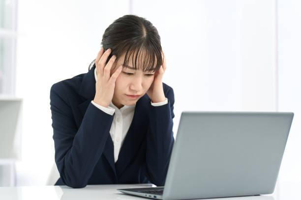istock Business woman holding her head in front of a computer 2150521235