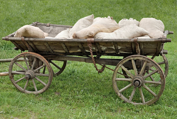 istock Old wood cart loaded with sacks 2150521349