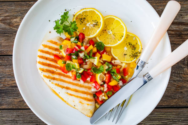 istock Grilled chicken breast and fresh vegetables on wooden table 2150522302