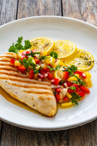 istock Grilled chicken breast and fresh vegetables on wooden table 2150522324