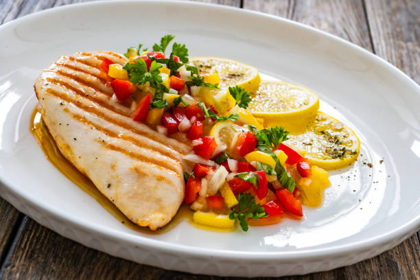 istock Grilled chicken breast and fresh vegetables on wooden table 2150522333