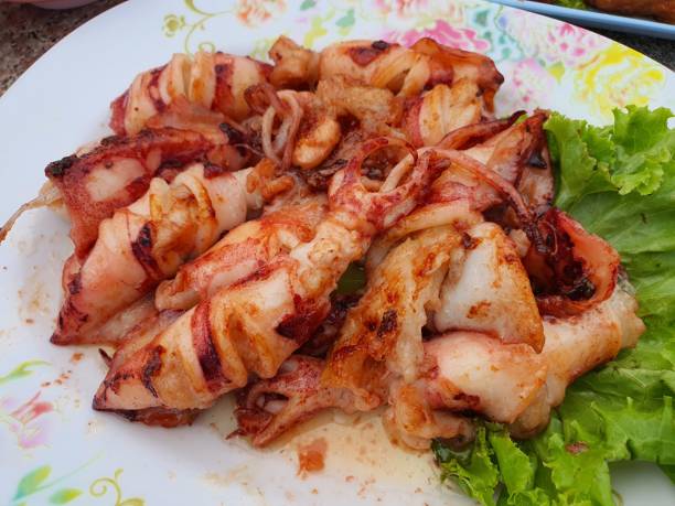 istock Grilled Squid on White Plate with Lettuce 2150522553