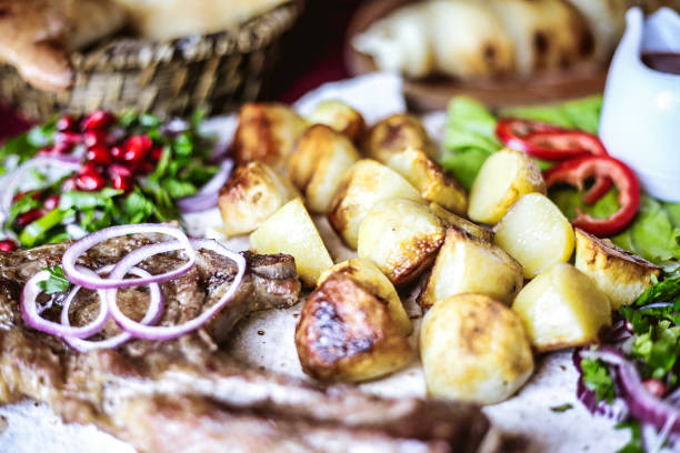 Prepared dish with partially cut steak, hash browns and salads