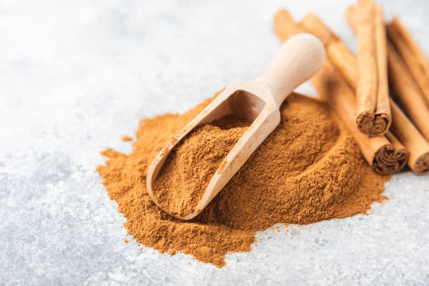 istock Cinnamon powder  on a textured wooden background. Spicy spice for baking, desserts and drinks. Fragrant ground cinnamon. Cinnamon stick. Place for text. Copy space. 2150522886